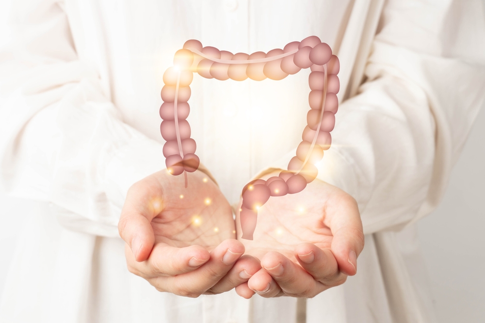 An image of hands with a graphic of the colon