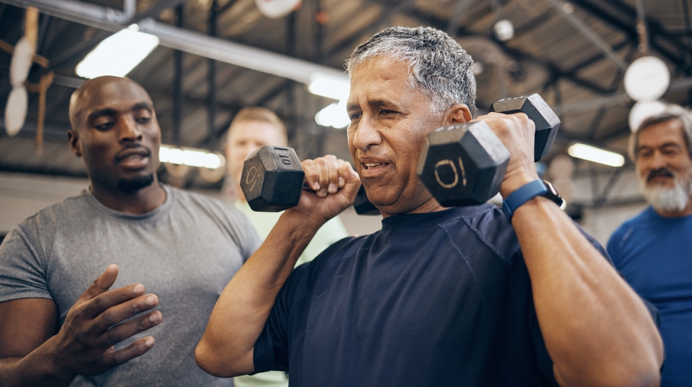A man using hand weights in a gym setting